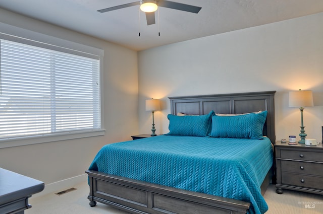 bedroom featuring light colored carpet and ceiling fan