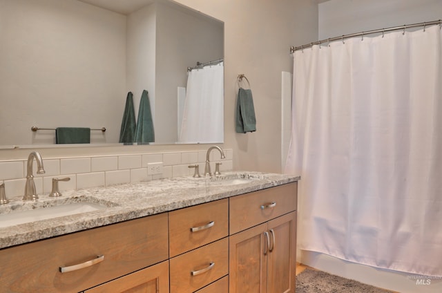 bathroom featuring vanity and decorative backsplash