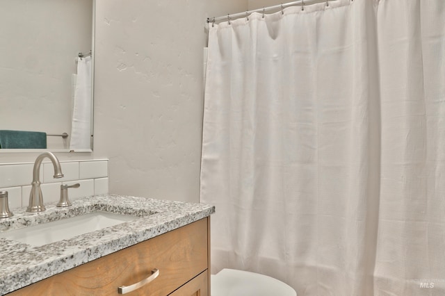 full bathroom with vanity, tasteful backsplash, shower / bath combo, and toilet