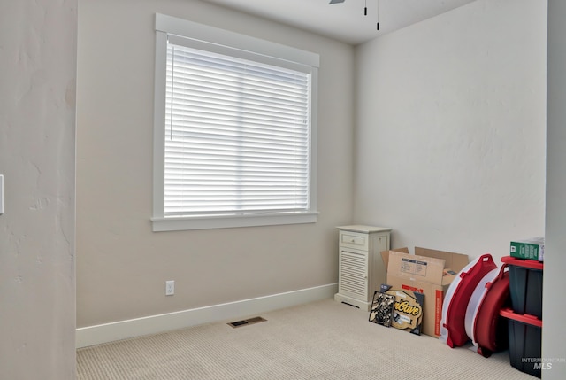 misc room featuring ceiling fan and light carpet