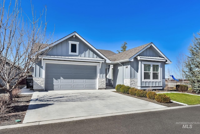 view of front of home featuring a garage, driveway, a shingled roof, stone siding, and board and batten siding