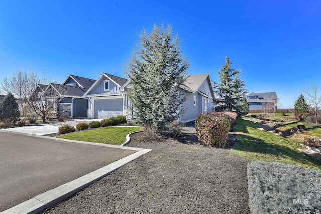 view of front of house with board and batten siding, driveway, and a garage