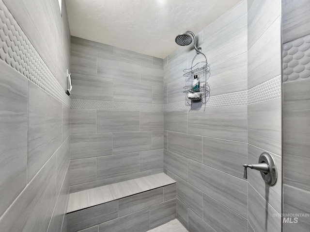 bathroom with tiled shower