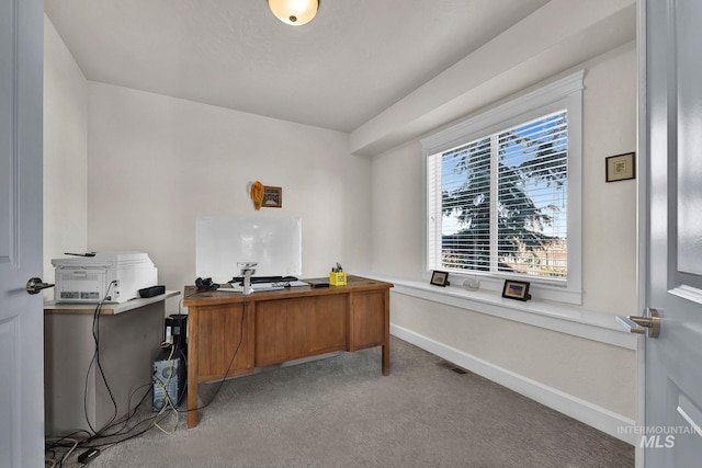 office space with light carpet, visible vents, and baseboards