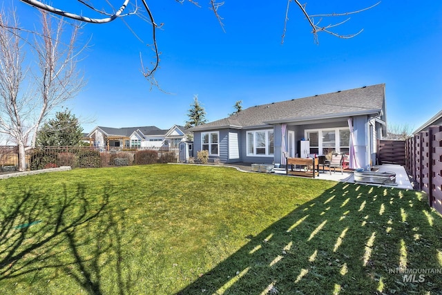 back of property featuring a patio area, a fenced backyard, and a yard