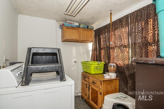 clothes washing area featuring washer and dryer and a textured ceiling