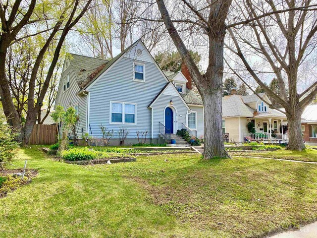 bungalow-style house featuring fence and a front yard