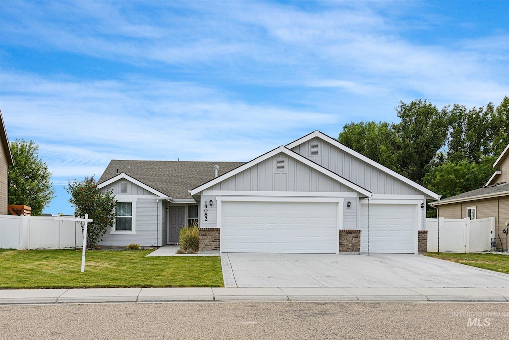 19082 Kenney Way, Caldwell, ID 83605 - view of front of home featuring a garage, driveway, board and batten siding, and brick siding