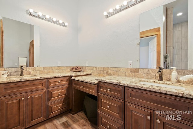 bathroom featuring hardwood / wood-style flooring and vanity