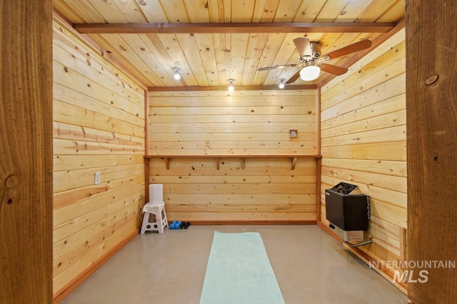 spare room featuring wood ceiling, wood walls, and concrete floors