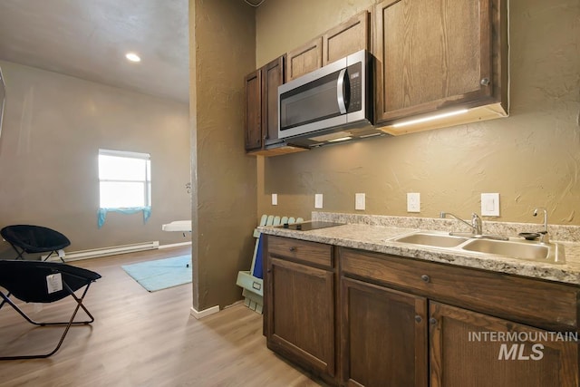 kitchen with light hardwood / wood-style floors and sink