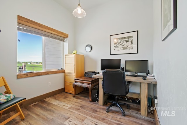 home office with hardwood / wood-style flooring