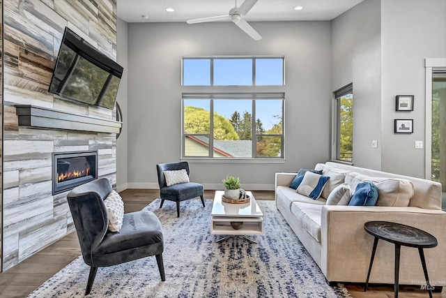 6420 W Glencrest Ln, Boise, ID 83714 - living room with a ceiling fan, wood finished floors, a high end fireplace, a towering ceiling, and recessed lighting