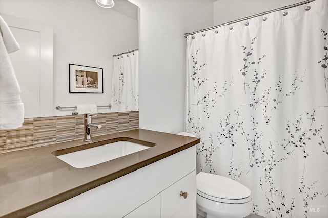 6420 W Glencrest Ln, Boise, ID 83714 - full bathroom with tasteful backsplash, toilet, vanity, and a shower with curtain