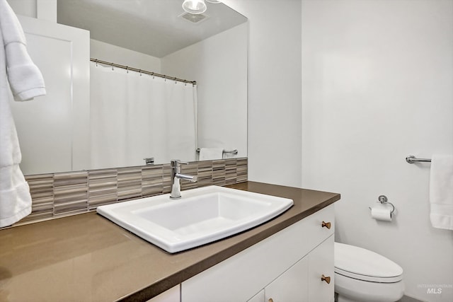 6420 W Glencrest Ln, Boise, ID 83714 - bathroom featuring toilet, tasteful backsplash, vanity, and visible vents