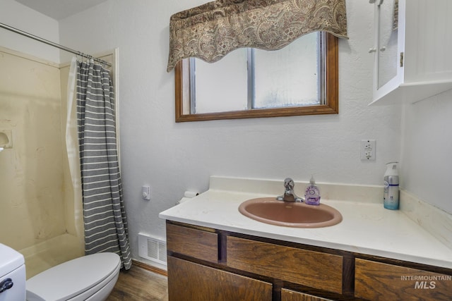 561 3rd Ave N, Twin Falls, ID 83301 - full bath with toilet, vanity, a shower with shower curtain, and wood finished floors