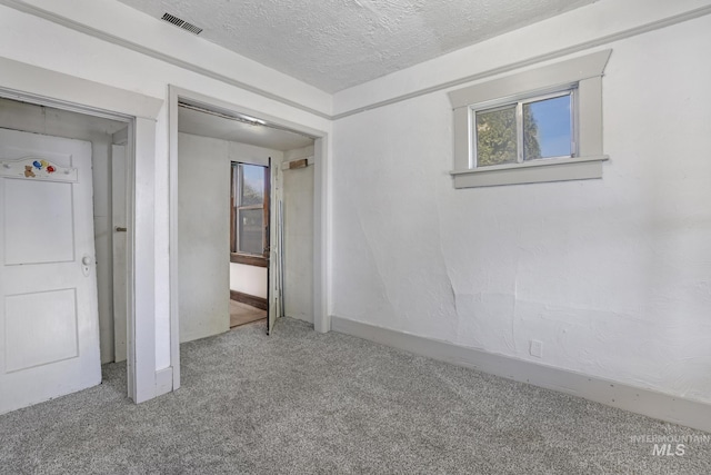 561 3rd Ave N, Twin Falls, ID 83301 - unfurnished bedroom featuring carpet floors, a textured ceiling, a closet, and baseboards