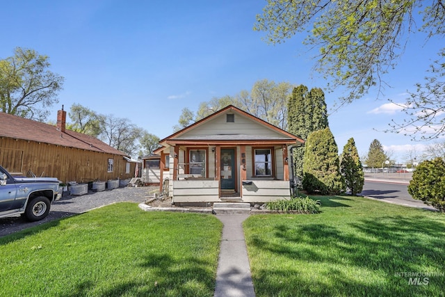 561 3rd Ave N, Twin Falls, ID 83301 - view of front of house featuring a front lawn and covered porch