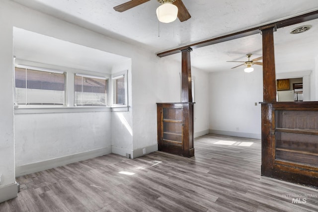 561 3rd Ave N, Twin Falls, ID 83301 - unfurnished living room with a ceiling fan, baseboards, and wood finished floors