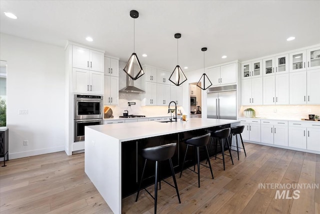 1093 N Morehouse Ave, Eagle, ID 83616 - kitchen with backsplash, stainless steel appliances, light countertops, and light wood-style floors