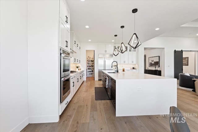 1093 N Morehouse Ave, Eagle, ID 83616 - kitchen with light countertops, a sink, light wood finished floors, backsplash, and stainless steel appliances