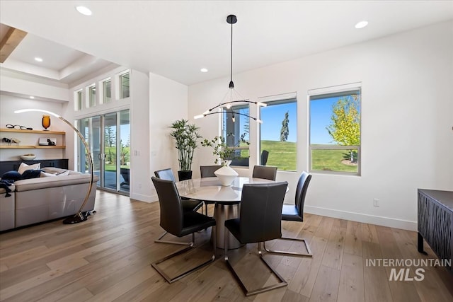 1093 N Morehouse Ave, Eagle, ID 83616 - dining room with light wood-style floors, baseboards, and a chandelier