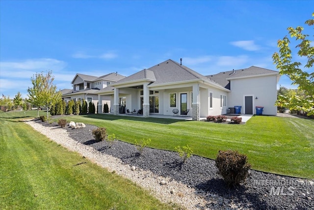 1093 N Morehouse Ave, Eagle, ID 83616 - back of house featuring a lawn, a patio area, and stucco siding