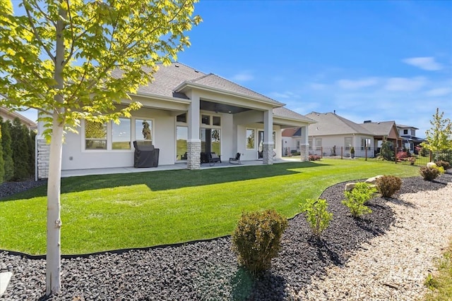 1093 N Morehouse Ave, Eagle, ID 83616 - rear view of property with a lawn, a shingled roof, stucco siding, and a patio area