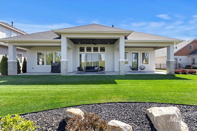 1093 N Morehouse Ave, Eagle, ID 83616 - back of property with a ceiling fan, a patio area, stucco siding, and a yard