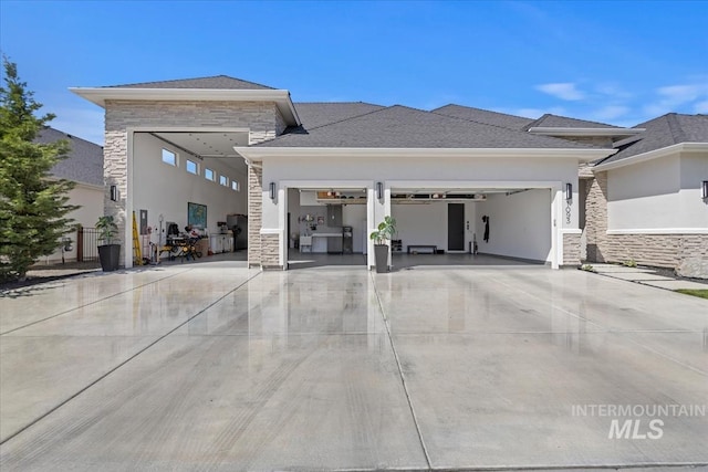 1093 N Morehouse Ave, Eagle, ID 83616 - rear view of property with a garage, stucco siding, concrete driveway, and stone siding
