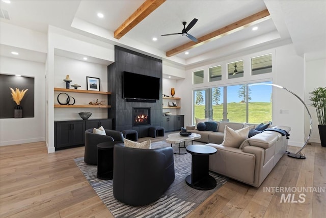 1093 N Morehouse Ave, Eagle, ID 83616 - living area featuring beam ceiling, a fireplace, light wood-style floors, a ceiling fan, and baseboards