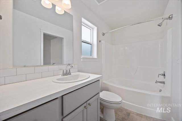 bathroom featuring vanity, shower / tub combination, and toilet