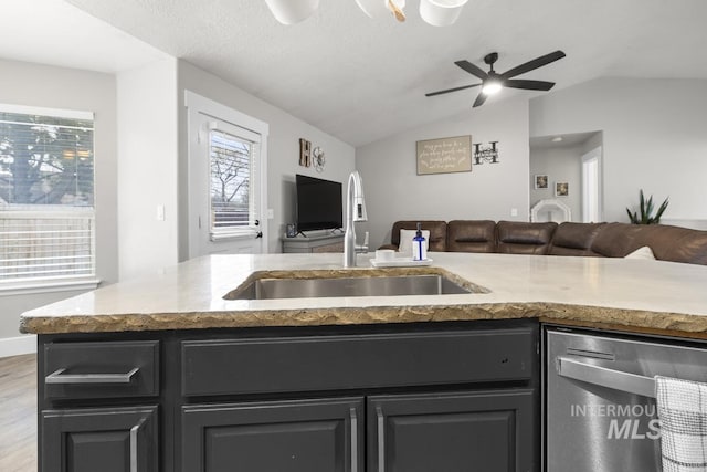 kitchen with ceiling fan, sink, light hardwood / wood-style flooring, stainless steel dishwasher, and lofted ceiling