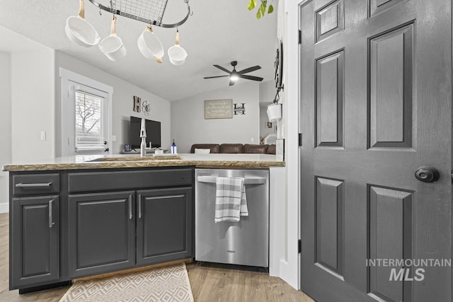 kitchen featuring kitchen peninsula, vaulted ceiling, ceiling fan, light hardwood / wood-style flooring, and dishwasher