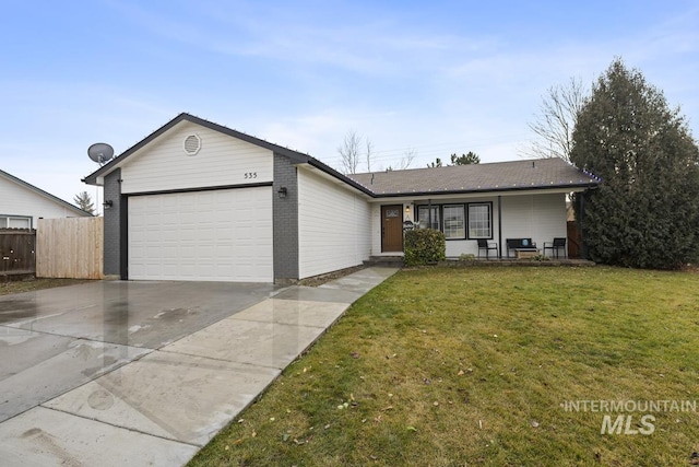 single story home with a garage and a front lawn