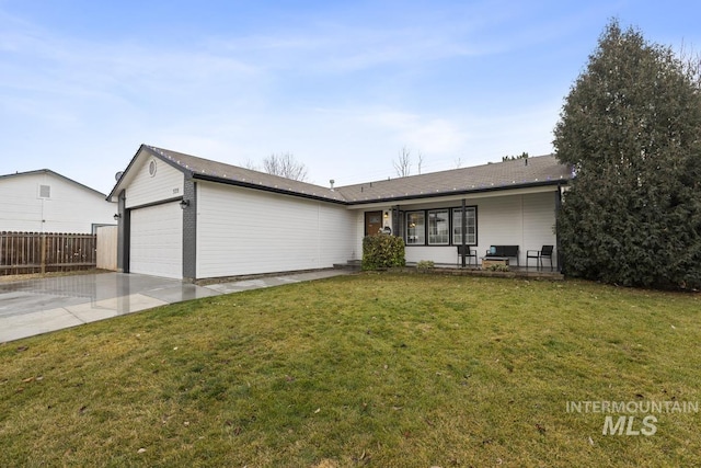 ranch-style house with a garage and a front lawn