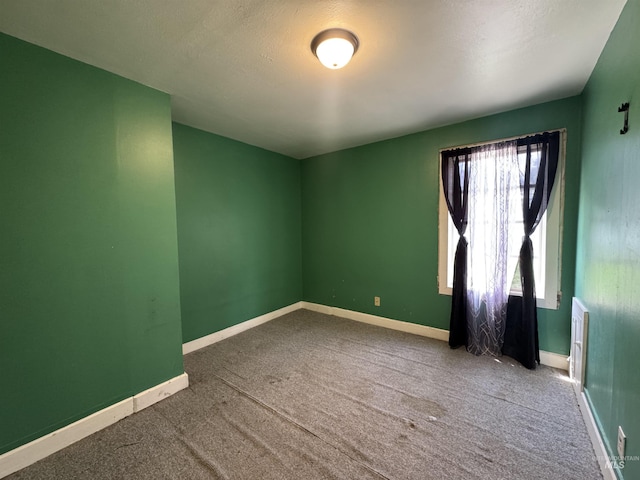 104 E B St, Shoshone, ID 83352 - spare room featuring carpet floors, baseboards, and a textured ceiling