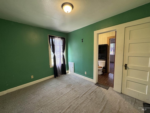 104 E B St, Shoshone, ID 83352 - unfurnished bedroom featuring carpet floors, multiple windows, and baseboards