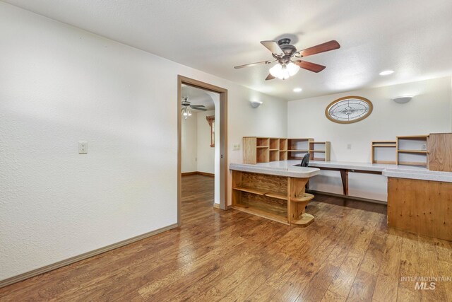 home office featuring wood-type flooring and ceiling fan