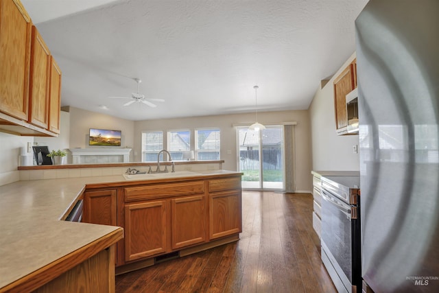 1460 N Pointe Dr, Twin Falls, ID 83301 - kitchen featuring electric stove, freestanding refrigerator, a ceiling fan, a fireplace, and brown cabinetry