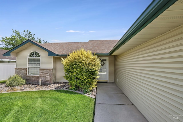 1460 N Pointe Dr, Twin Falls, ID 83301 - entrance to property featuring roof with shingles, brick siding, and a yard