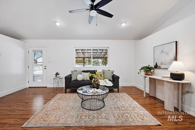 living room with lofted ceiling, dark hardwood / wood-style floors, and ceiling fan