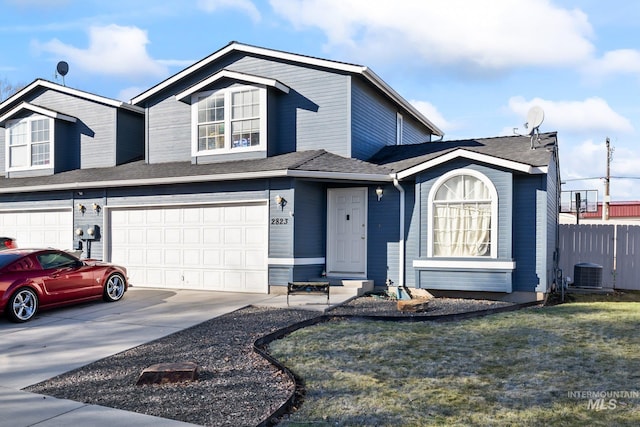 view of front facade featuring an attached garage, fence, central AC unit, and concrete driveway