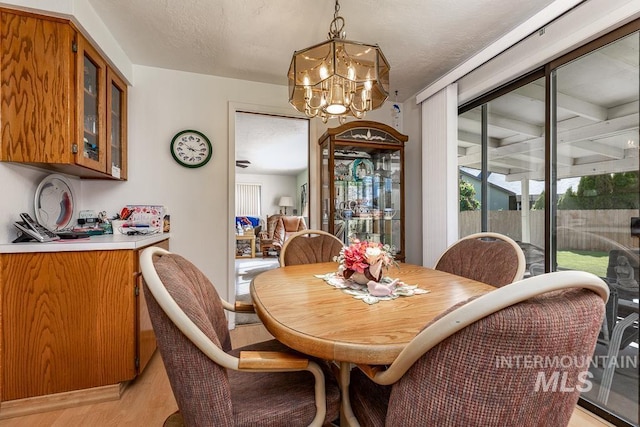 392 S Sun Burst Way, Boise, ID 83709 - dining room with light wood-style flooring and a chandelier