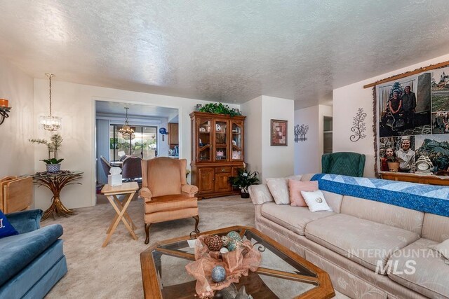 392 S Sun Burst Way, Boise, ID 83709 - living room featuring light carpet, a textured ceiling, and a chandelier