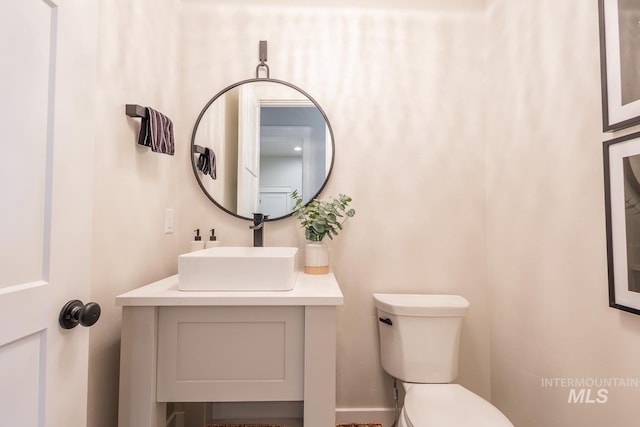 bathroom featuring vanity and toilet