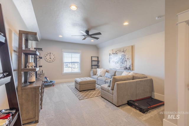 carpeted living room with a textured ceiling and ceiling fan