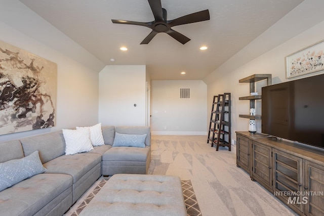 living room featuring light colored carpet and ceiling fan