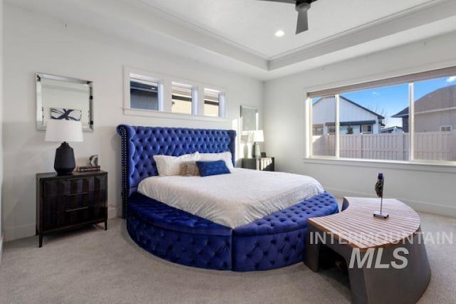 carpeted bedroom with a ceiling fan, a tray ceiling, baseboards, and recessed lighting