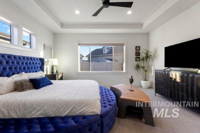 bedroom featuring ornamental molding, a tray ceiling, carpet flooring, and recessed lighting